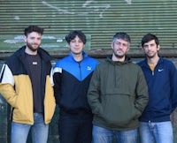 a group of men standing in front of a building